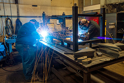 Welders working together to make a work table